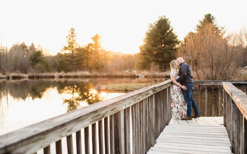 engaged couple kissing at sunset with pond in newark ohio