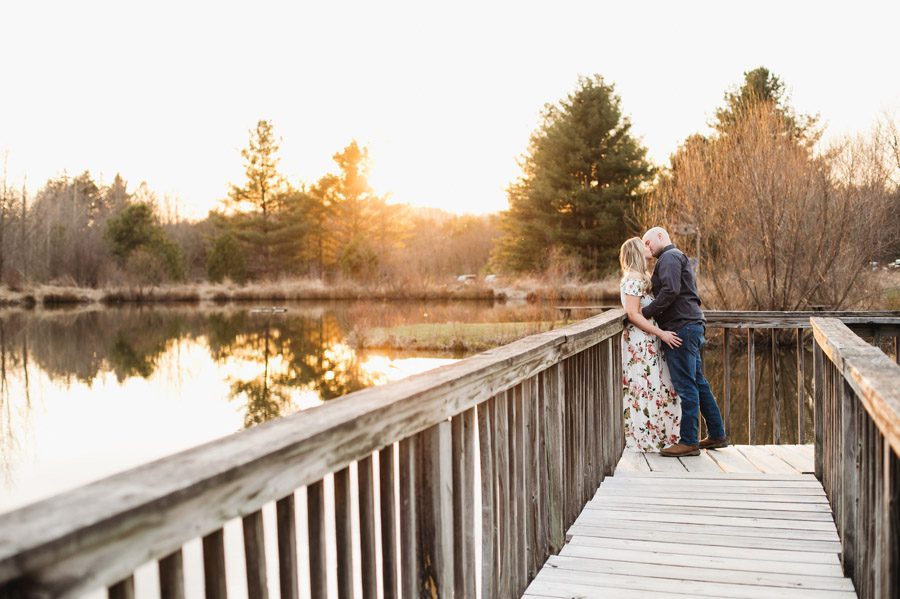 engaged couple kissing at sunset with pond in newark ohio