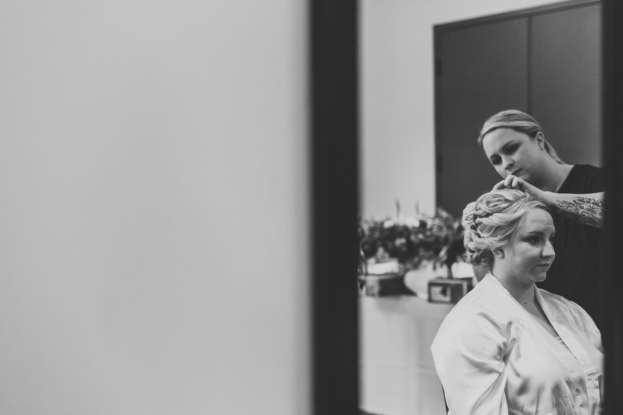 black and white photo of bride getting her hair done