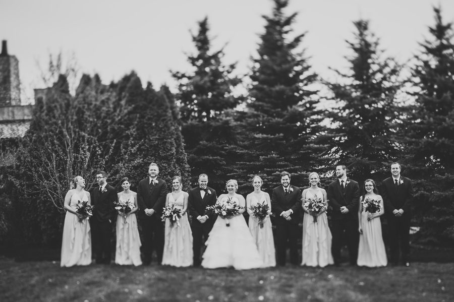 black and white photo of wedding party laughing