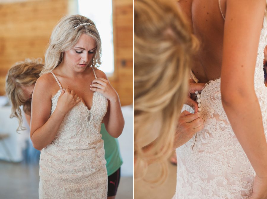 mother of bride buttoning up brides wedding gown