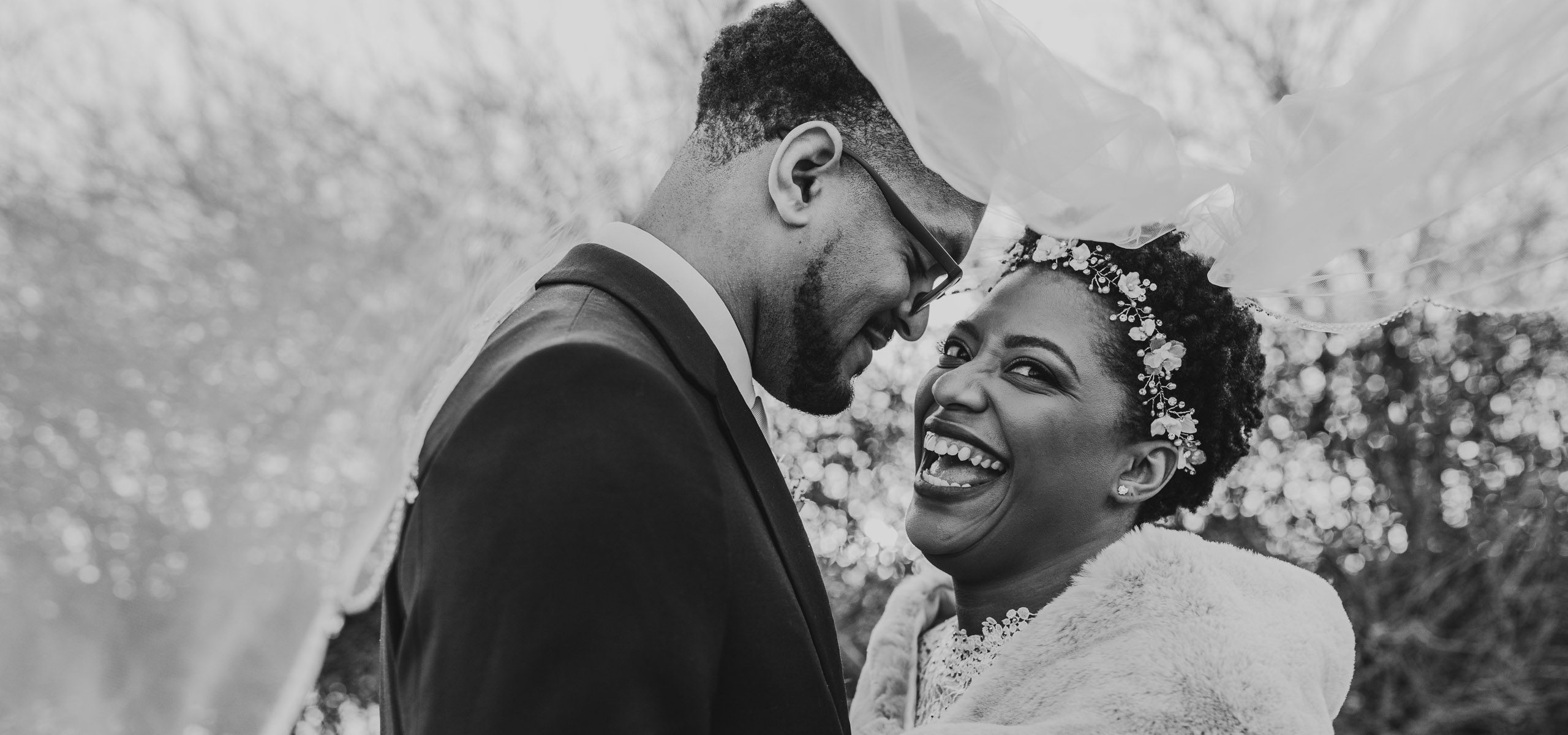 married couple under veil laughing at Columbus Ohio Wedding