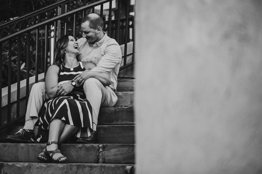 engaged couple sitting on steps at creekside gahanna engagement