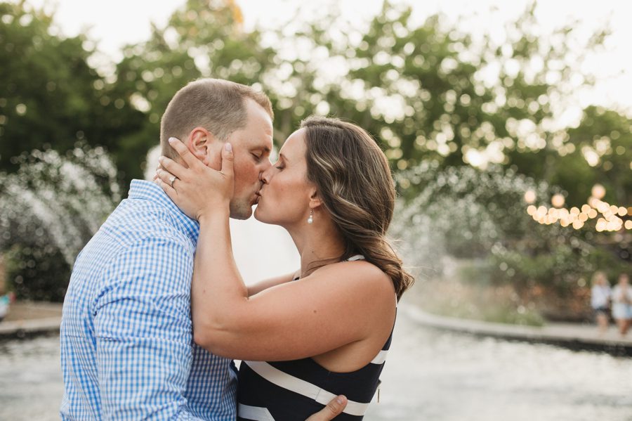 creekside gahanna engagement of couple kissing in front of water fountain