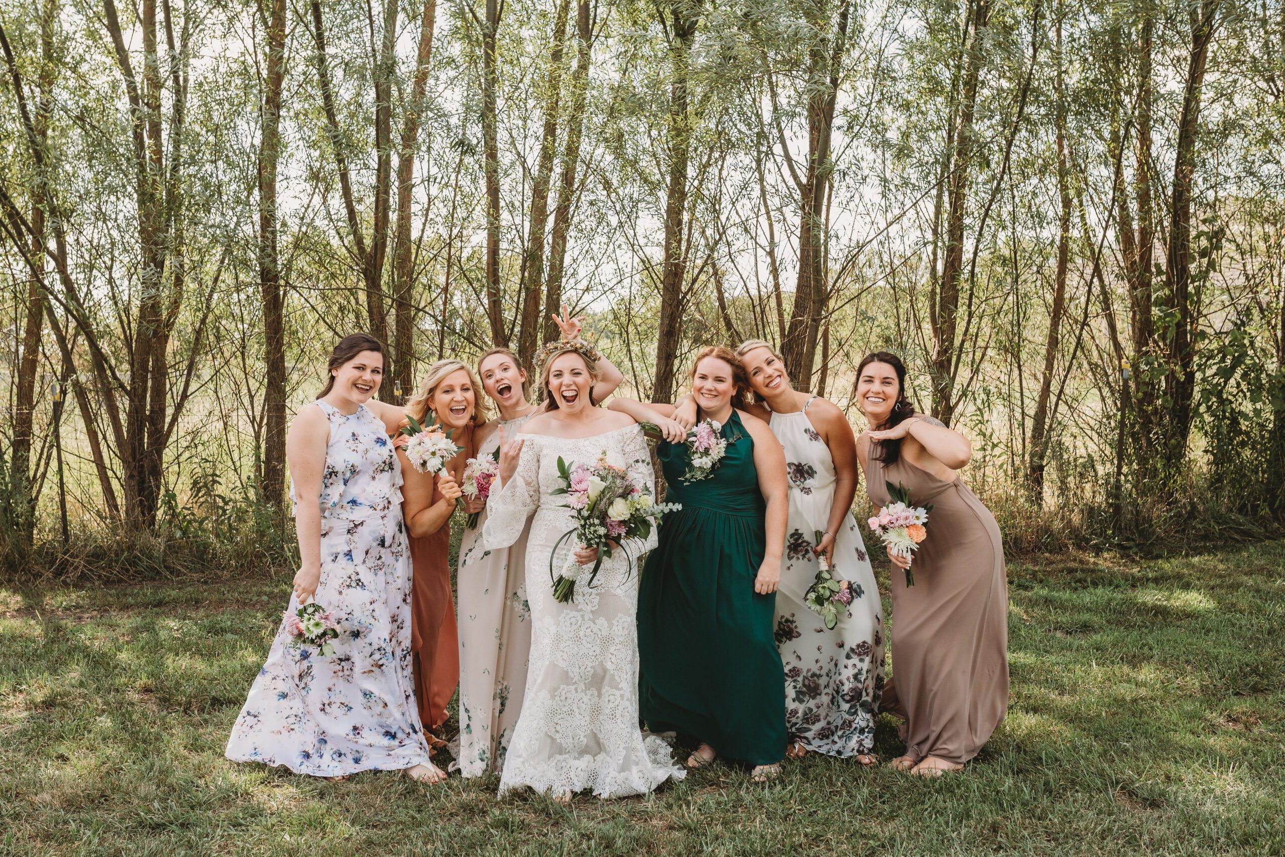bride with mix and match bridesmaids dresses on farm in Ohio