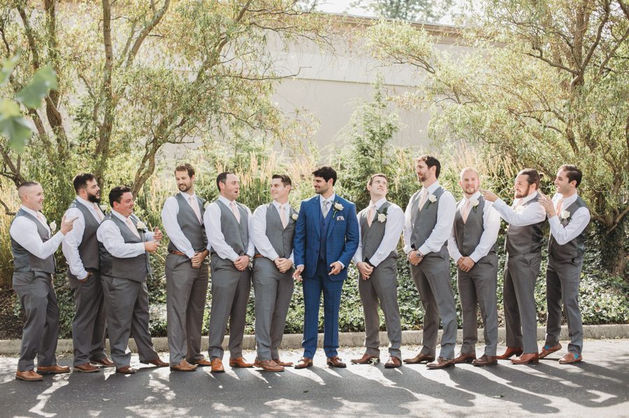 groom in blue suit with gray groomsmen suits