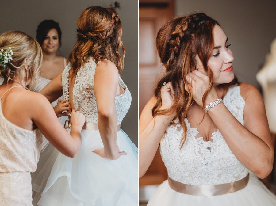 bride getting dressed into wedding gown