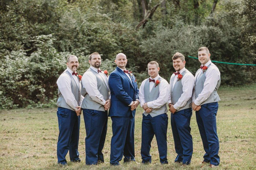 groom wearing navy suit with groomsmen wearing gray vests at Butler Ohio Wedding Photos