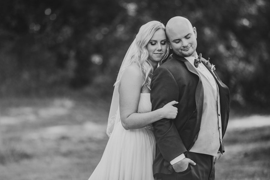 black and white image of bride hugging grooms back at Butler Ohio Wedding Photos