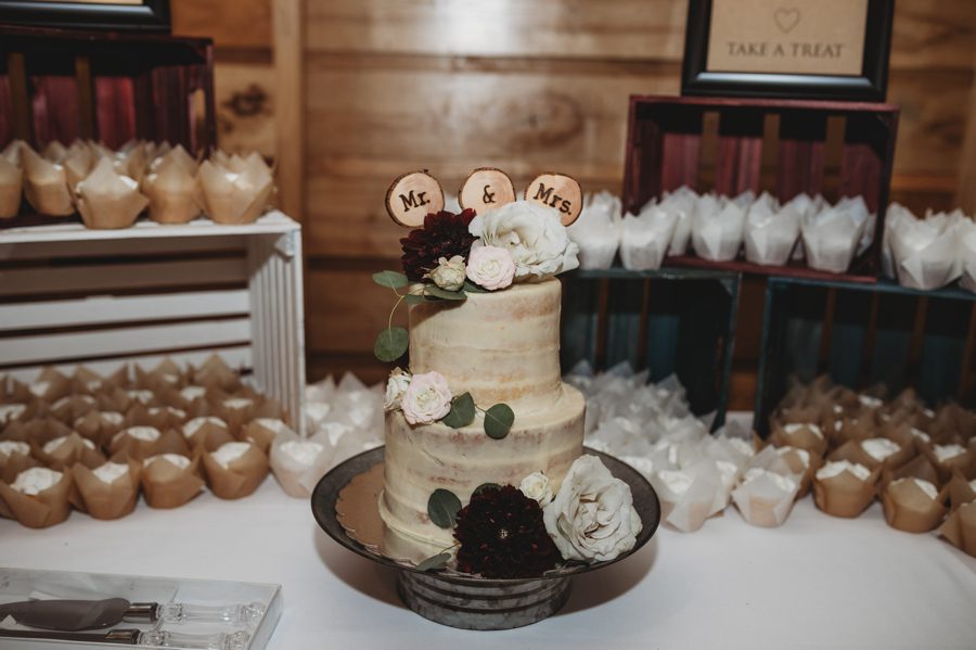 wedding cake with wooden mr and mrs sign
