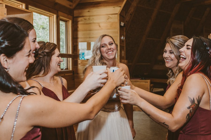 bride and bridesmaids cheering with drinks
