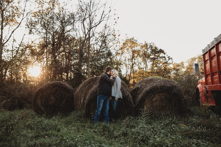 engaged couple kissing at sunset on farm at Camping Engagement Photos in Mount Vernon Ohio