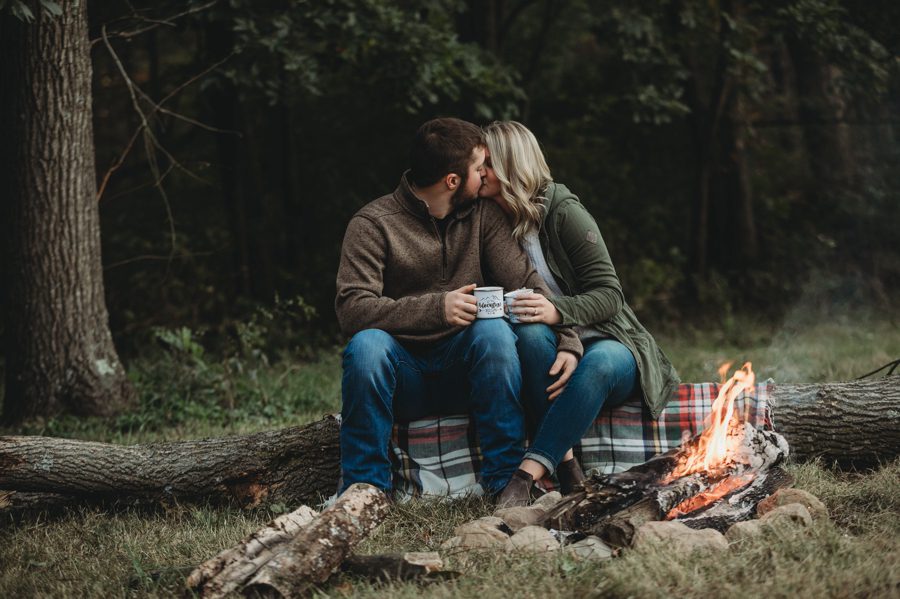 engaged couple kissing by bonfire at Camping Engagement Photos in Mount Vernon Ohio