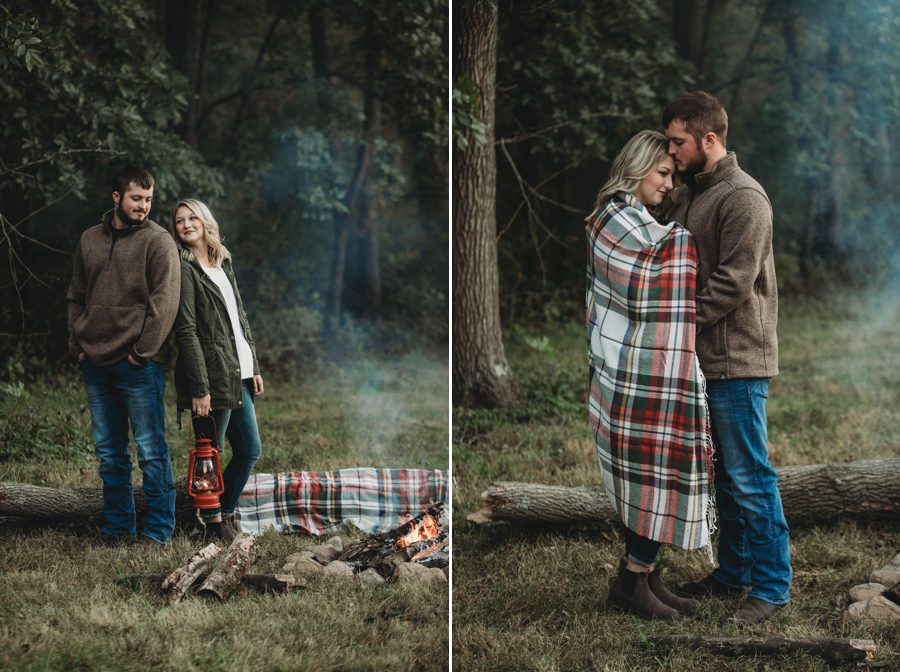 engaged couple standing back to back looking at each other by bonfire at Camping Engagement Photos in Mount Vernon 