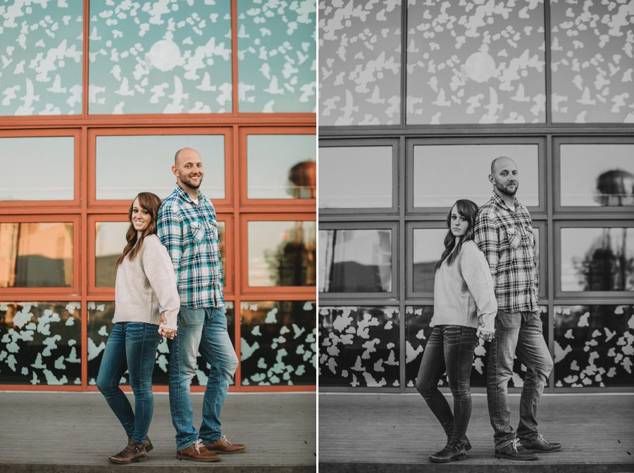 serious photo of engaged couple standing back to back while holding hands