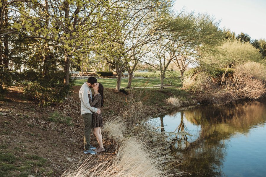 engaged couple kissing near pond at Homestead Park Engagement