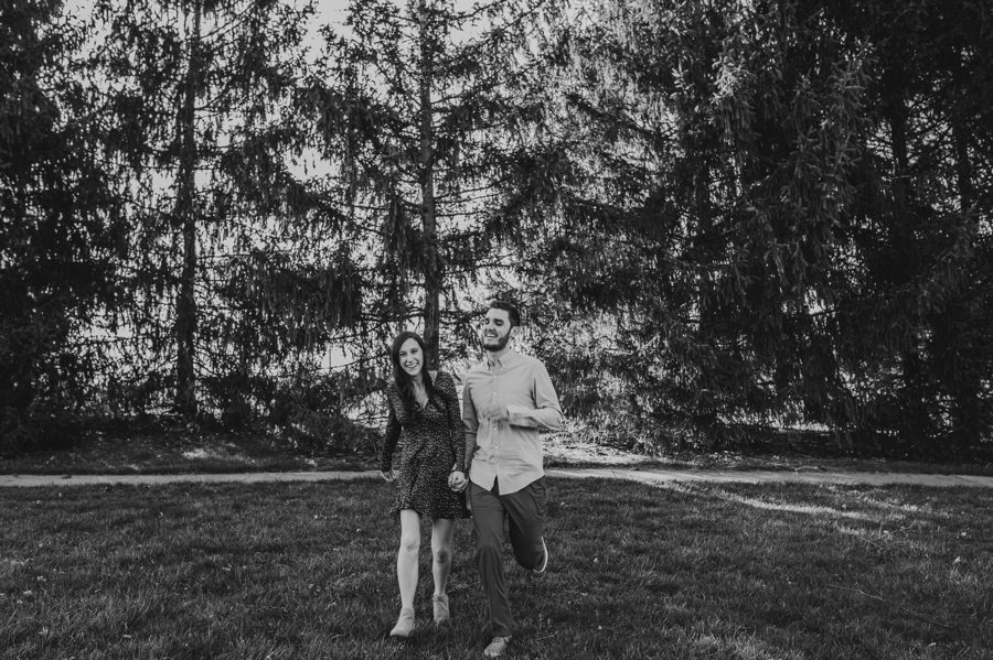 black and white image of engaged couple running at Homestead Park Engagement