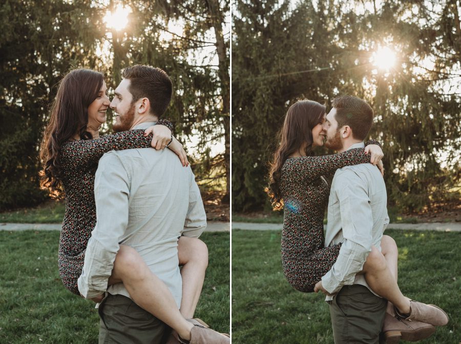 man holding fiancé around waist kissing