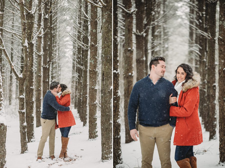 engaged couple kissing between tall pine trees in the winter at Hoover Reservoir Engagement