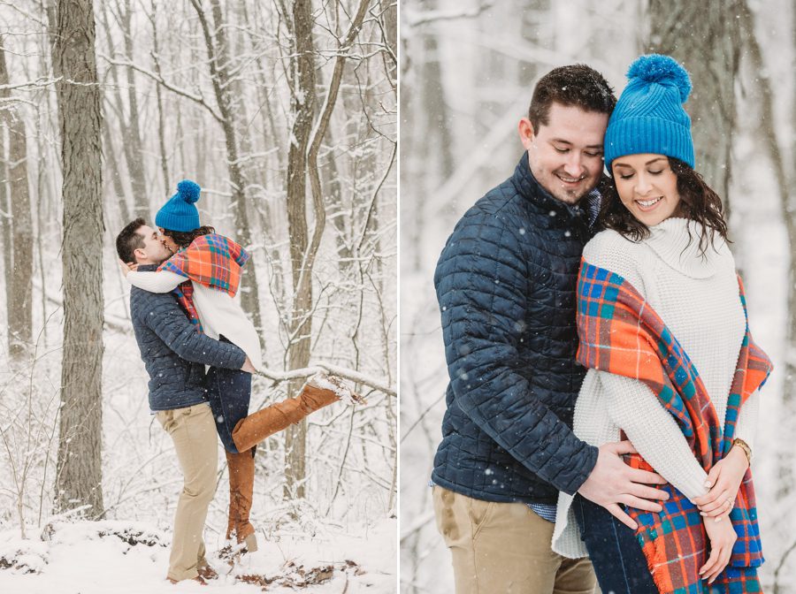 man holding fiancé in the air for a kiss in the snow at Hoover Reservoir Engagement