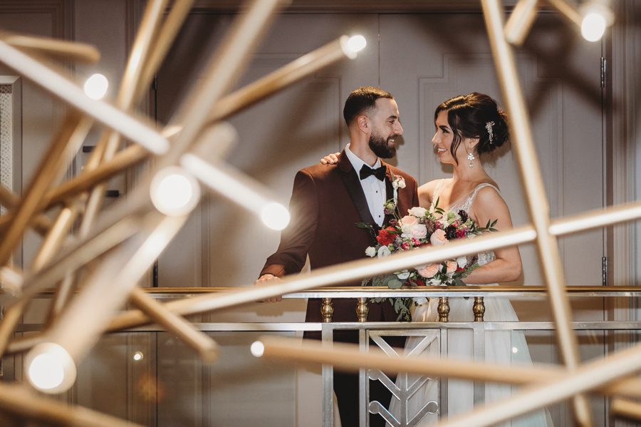 bride and groom with hotel leveque chandelier