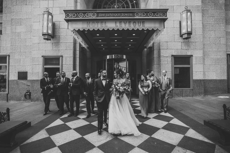 black and white photo of bridal party walking