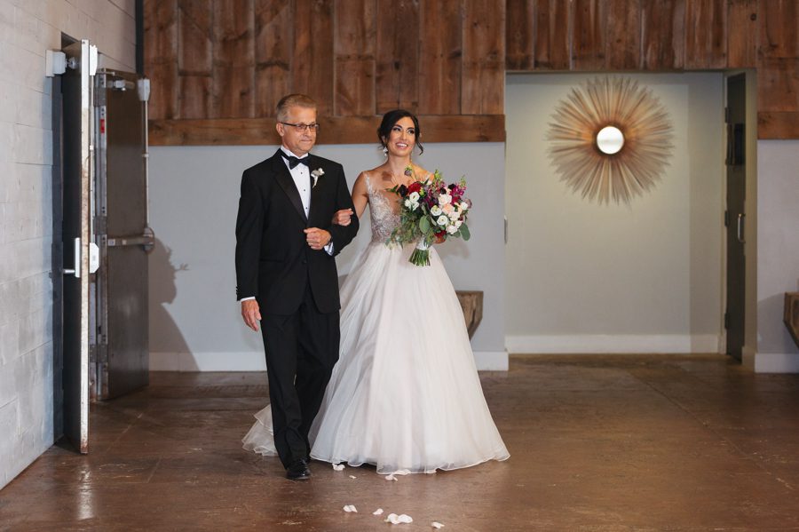 bride and father of bride walking down aisle