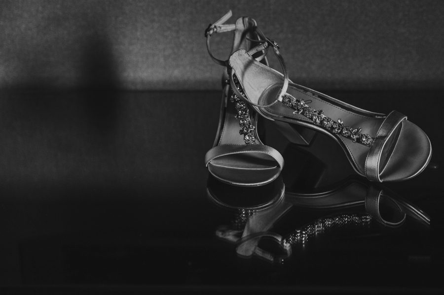 black and white photo of brides shoes
