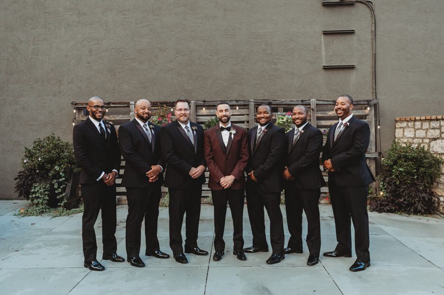 groom in maroon suit and groomsmen in black suits at Vue Columbus