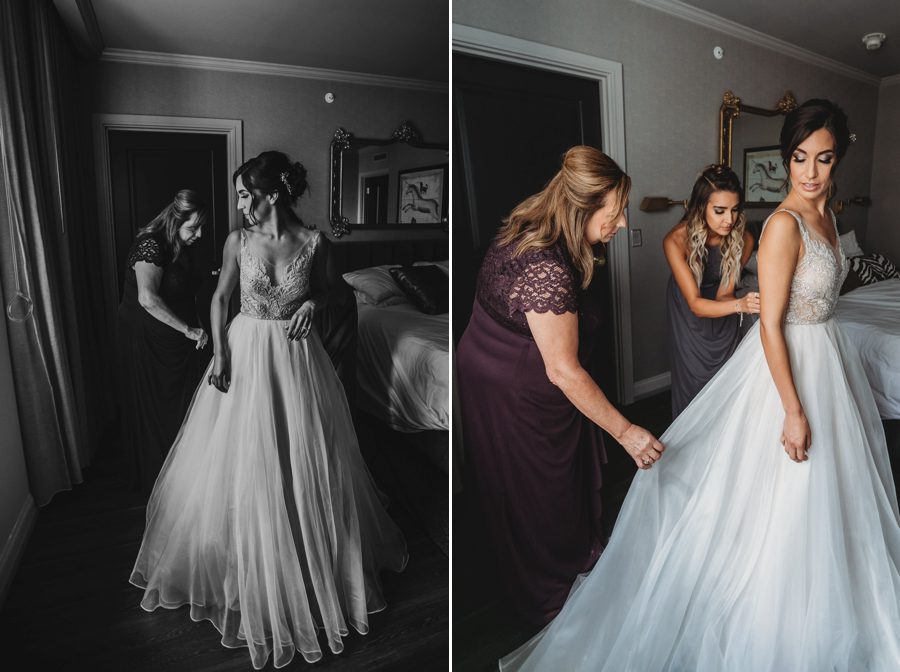 mother of bride helping bride get into gown at hotel leveque