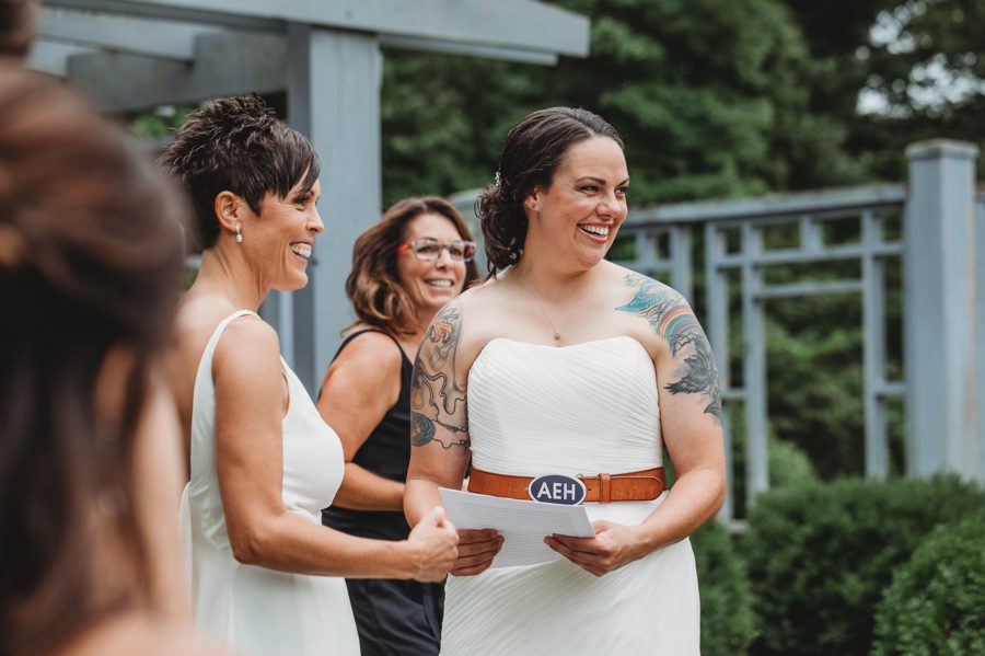 same sex couple laughing at wedding ceremony