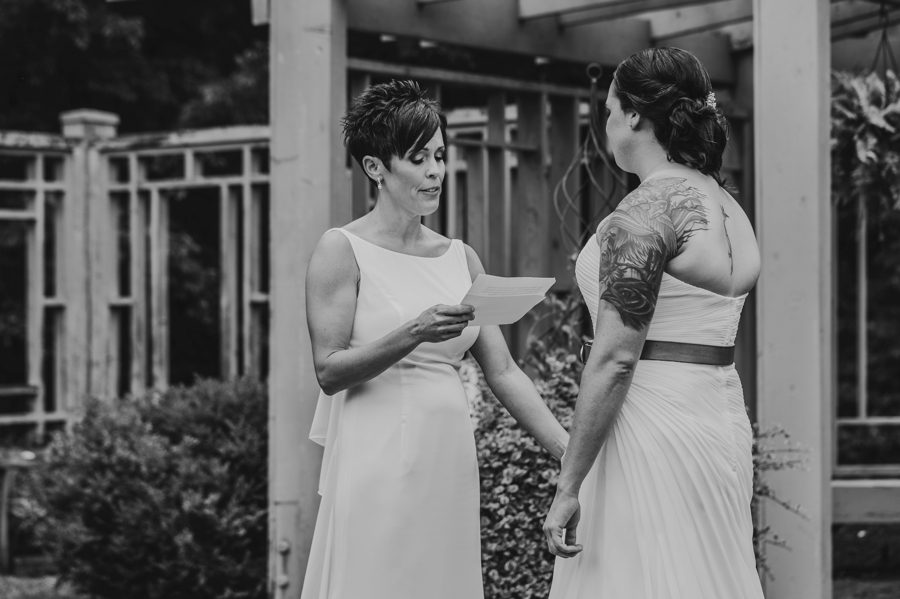black and white photo of bride reading vows