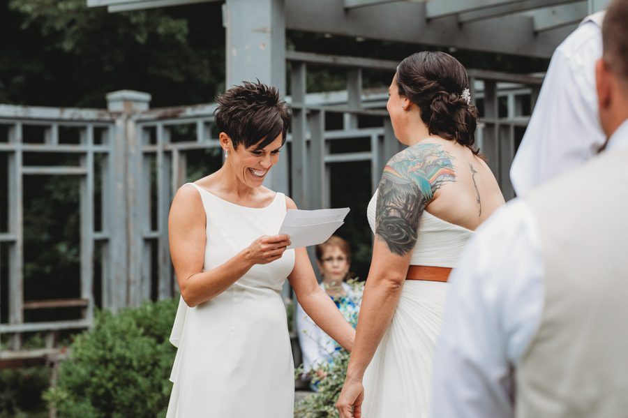 bride laughing during reading of vows