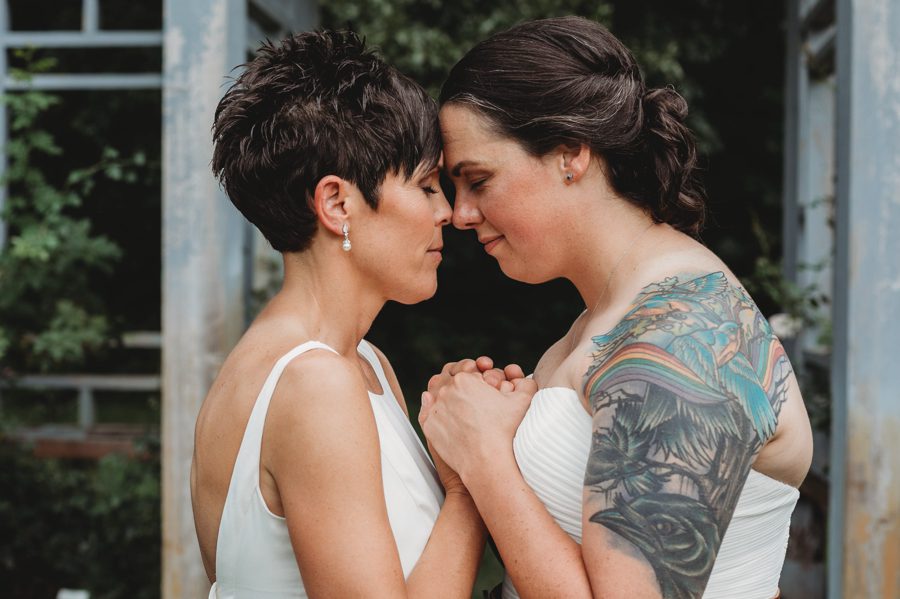 same sex couple with hands and foreheads together at Inniswood Micro Wedding