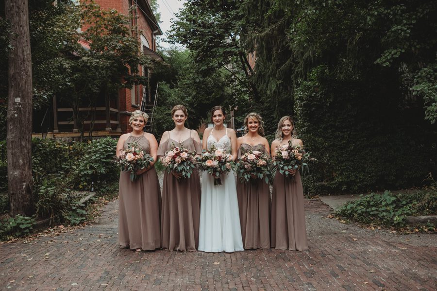 bride with bridesmaids in fawn colored dresses