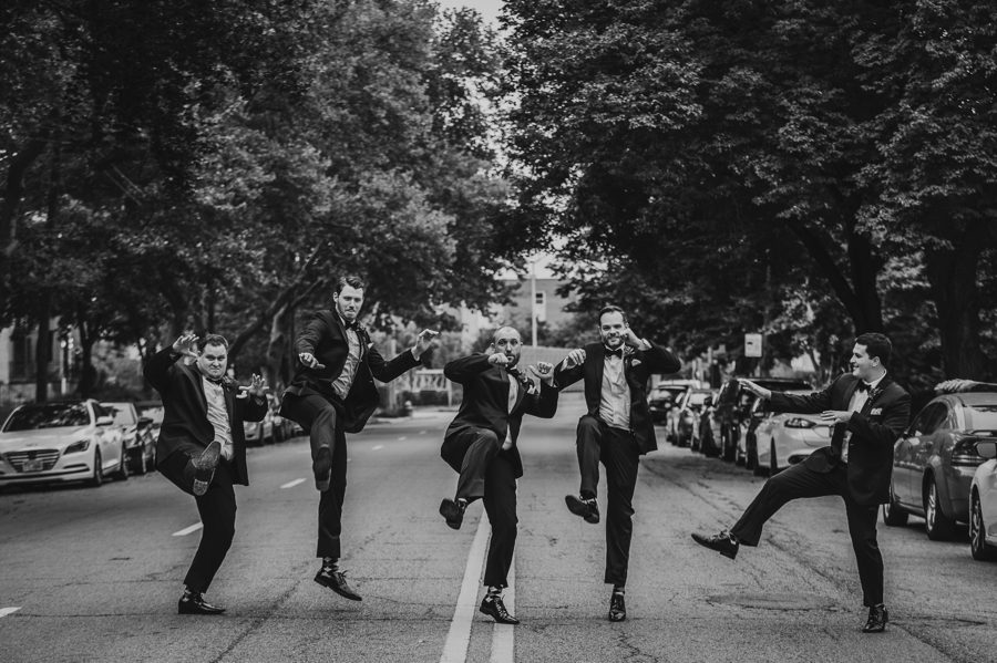 groom with groomsmen jumping and kicking at Kelton House Wedding