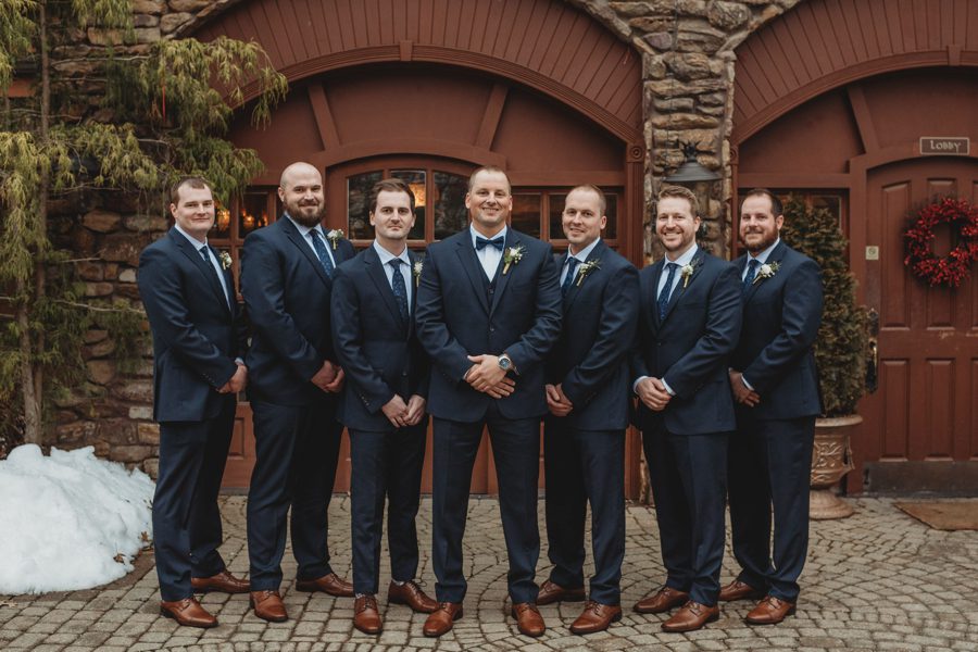 groom and groomsmen wearing navy suits with navy ties