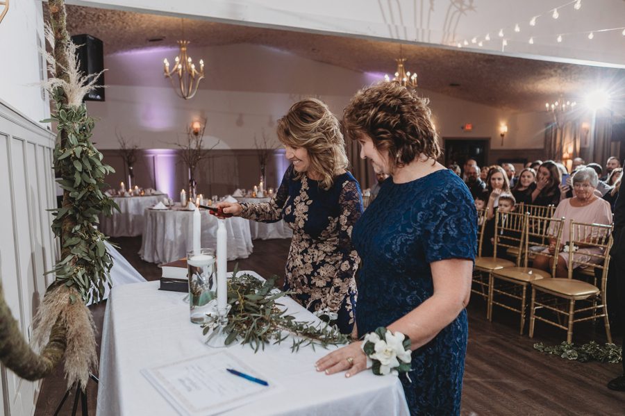 mother of bride and mother of groom lighting unity candles at Landolls Mohican Castle Wedding