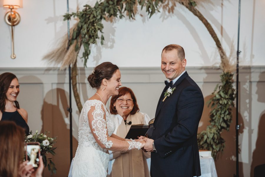 candid photo of bride and groom laughing during wedding ceremony
