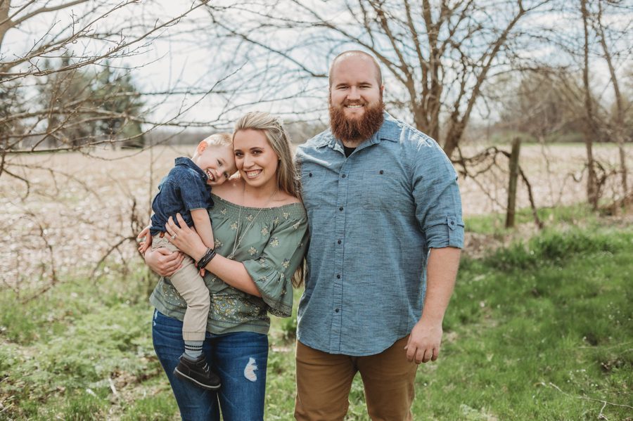 engaged couple with their toddler at private farm
