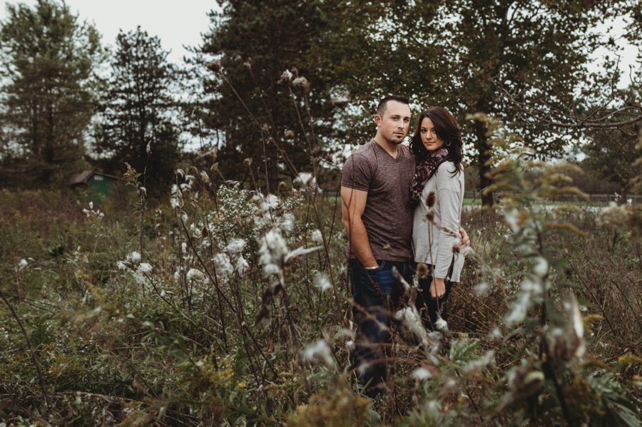 engaged couple in milkweed field for Newark Ohio Engagement Photos