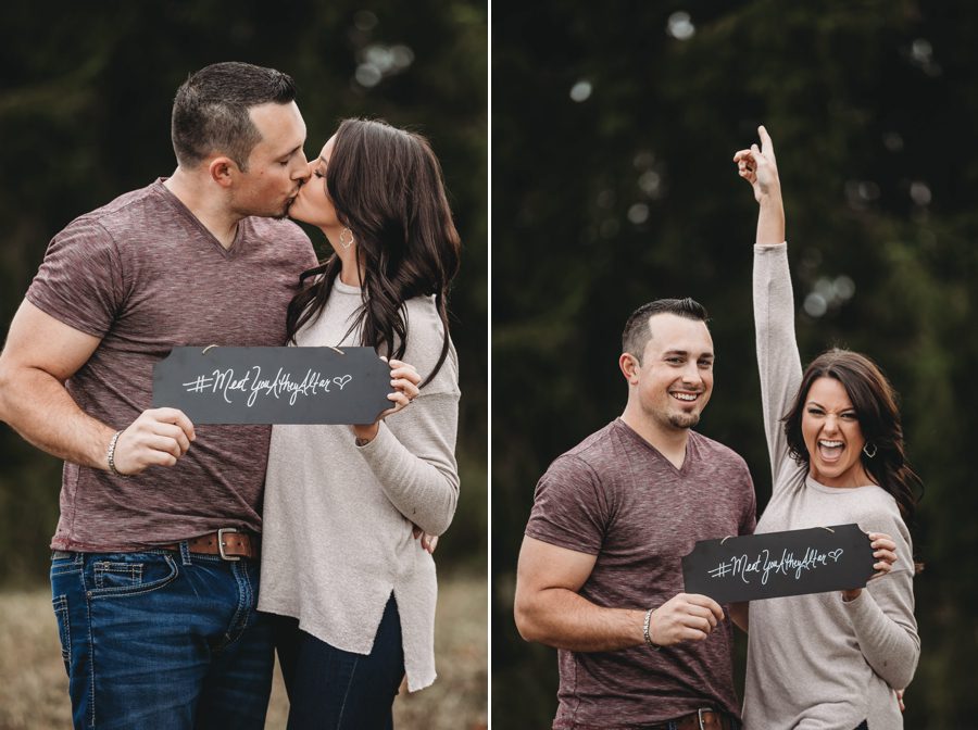 engaged couple holding hashtag sign kissing