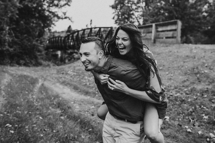 black and white image of engaged couple piggyback ride at Newark Ohio Engagement Photos