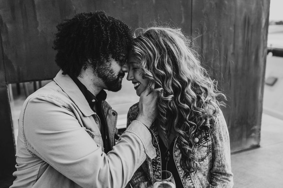black and white image of engaged couple with foreheads together