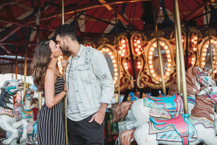couple kissing on carousel