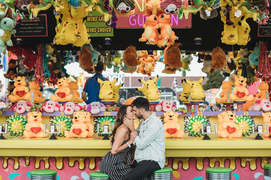 romantic photo of engaged at game booth at Ohio state fair