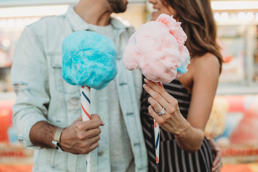 cotton candy held by bride and groom