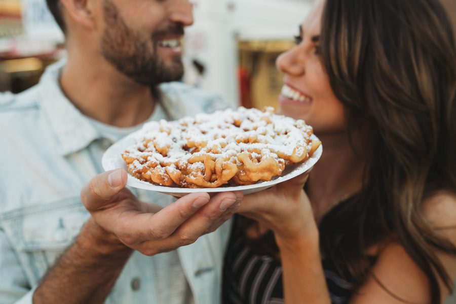 engaged couple with funnel cake