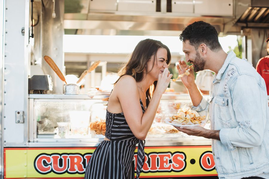 engaged couple eating a funnel cake at Ohio State Fair