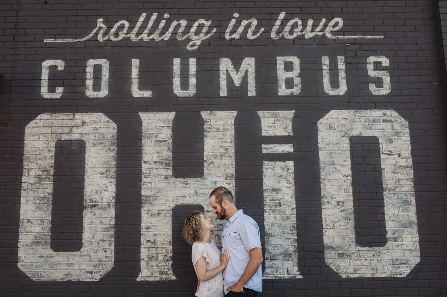 Pins Mechanical Engagement photo of couple looking at each other in front of Columbus Ohio mural